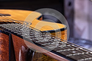 Close-up of a guitar fretboard on a blurred background