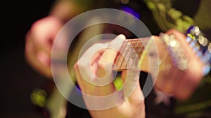 Close-up of a guitar in the hands of a guitarist