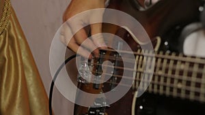 Close-up of guitar playing. Guitarist hits the strings of the guitar. Skill. Playing a musical instrument. Stringed