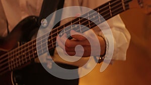 Close-up of guitar playing. Guitarist hits the strings of the guitar. Skill. Playing a musical instrument. Stringed