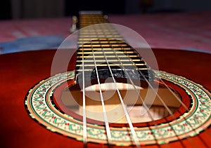 Close up of guitar strings. Brown classical guitar