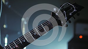 Close up of guitarist playing the electric guitar on stage. Performance music video rock, punk, heavy metal band.