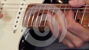 Close-up of a guitarist`s hand on the fretboard of the guitar playing showing how to do correctly the bending and the vibrato tech