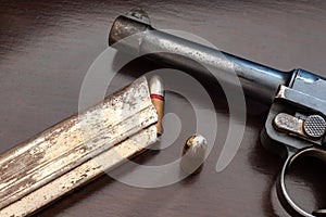 gunpoint and bullets on table. Weapons and ammunition photo
