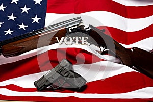 Guns with the letters vote in front of the American flag