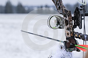Close-up  Gunsight on the hunting bow. Winter season and snowy landscape