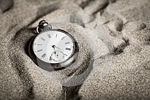 A close-up gusset watch in the sand photo