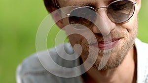 Close-up of guy`s face wearing sunglasses