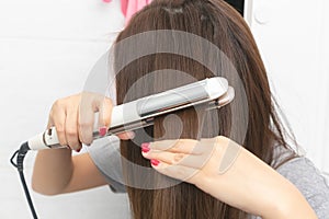 Close up Hair iron straightening beauty care in dressing room