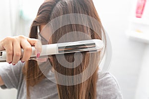 Close up Hair iron straightening beauty care in dressing room