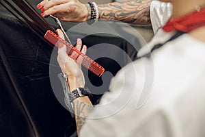 Close up of hairdresser is cutting hair for customers with scissors to cut hair in a beauty salon