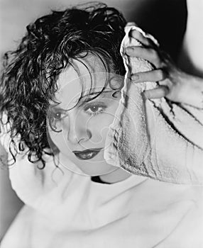 Close-up of a hairdresser's hand drying a young woman's hair