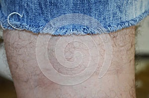 Close up the hairy leg of a man