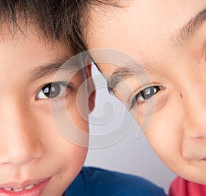 Close up on half eyes of sibling brother smiling together