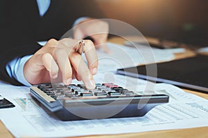 close up hand accountant using calculator with laptop. concept s