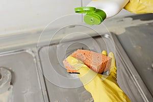 Extruding the detergent onto the sponge, close-up photo