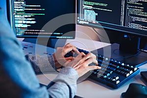 close up hand of Asian prompt engineer develop coding app with software data sitting in front of computer monitor at office