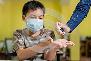 Close up hand of asian teacher and children with face mask back at school after covid-19 quarantine and lockdown and using