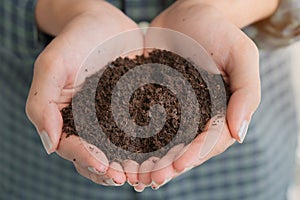 Close up hand of asian woman holdling fertilizer compost in her hand, Selective focus