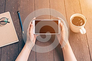 Close up hand asian woman using phone in coffee shop and sunlight with vintage filter.