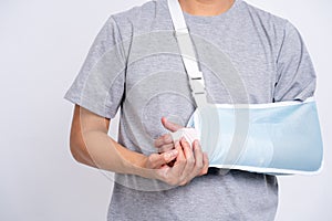 Close up hand with bandage isolate on white background as man arm injury concept. Asian boy with broken arm or hand dislocation