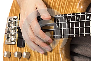 Close-up of a hand on a bass guitar