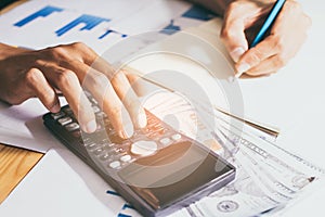 Close-up. Hand of  business or account working calculator, profit or graph economy on home office table