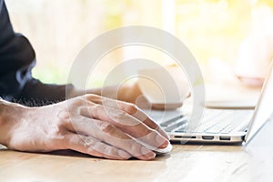 Close up hand business man using mouse and laptop