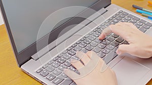 Close up hand of business woman typing on keyboard working with computer laptop. Hands of woman chatting or writing article on