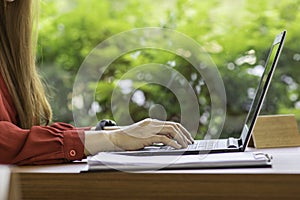 Close up hand of business woman working with laptop