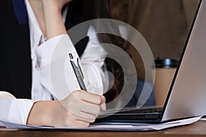 Close up hand business women note job  on graph in business meeting