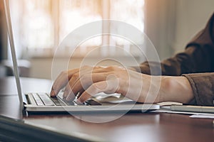 Close up hand of businessman using laptop working in office.