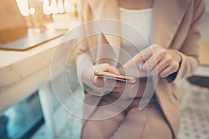 Close up hand of businesswoman using mobile smart phone