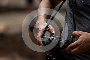 Close up hand and butterfly.  Professional photographer man holding camera for taking butterfly in the green jungle rain forest na