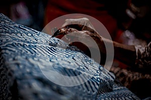 Close Up hand and canting, making batik Tulis Indonesia