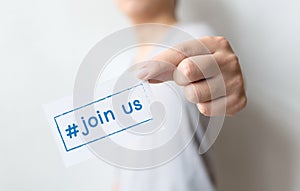 Close up hand of casual man holding white card with text hashtag