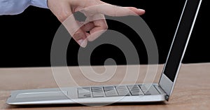 Caucasian woman finger pointing at a laptop screen shopping online