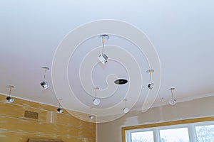 Close-up hand changes a light LED in a stylish preparations for ceiling lamp interior lighting installation photo