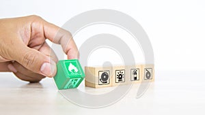 Close-up hand choose fire prevent symbol on wooden toy block stacked