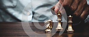 Close-up hand choose king chess on chess board Concept of business strategic plan