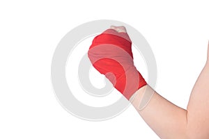 Close-up, hand clenched into a fist, wrapped in red bandages to protect the joints of the boxer, on a white background