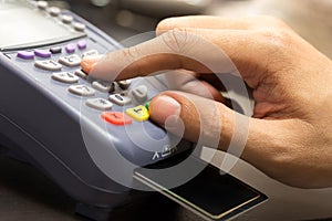Close Up Of Hand With Credit Card Swipe Through Terminal