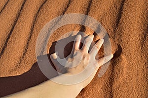 Close up of hand on the desert sand