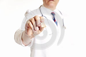 Close up, hand of a doctor holding tongue depressor. Health concept