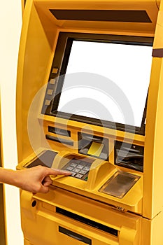 Close up of hand entering pin at an ATM. Finger about to press a pin code on a pad. Security code on an Automated Teller Machine