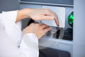 Close-up Of Hand Entering Pin At An ATM