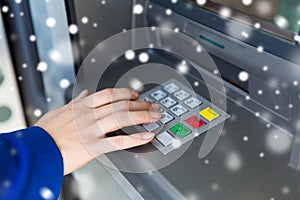 Close up of hand entering pin code at cash machine