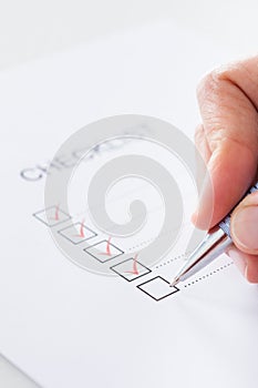 Close-up Of Hand Filling Form