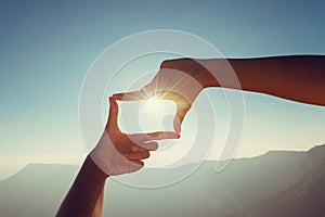 close up hand framing looking view sunrise