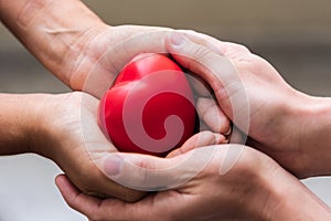 Close up hand giving red heart as heart donor. Valentine day of love concept. Medical ventilator and heart donator charity. Sign photo